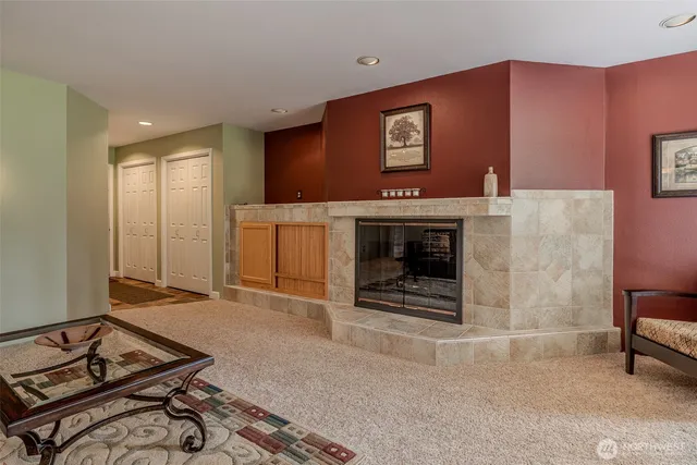 a living room with furniture a flat screen tv and a fireplace