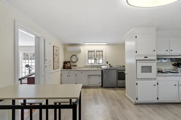a kitchen with sink a stove and cabinets
