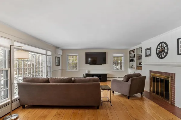 a living room with furniture fireplace and window