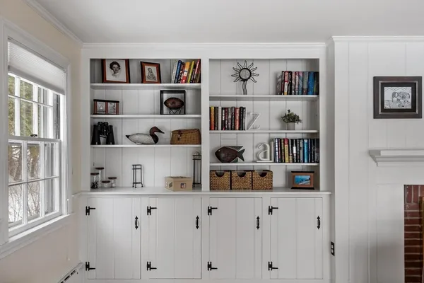 a shelf with books and knick knacks on it