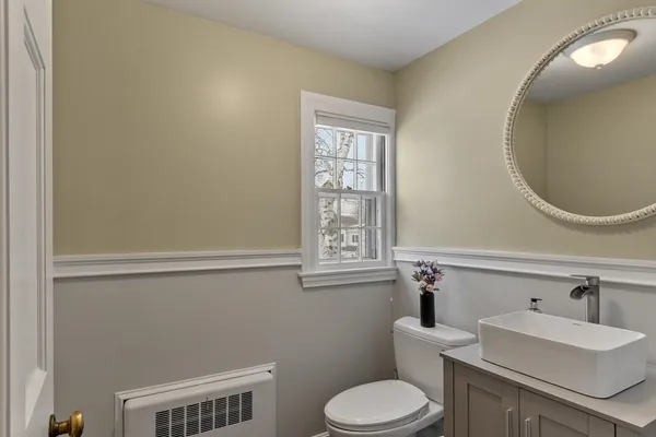 a bathroom with a sink a toilet and a mirror
