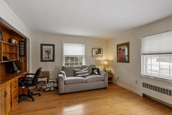 a living room with furniture window and a wooden floor