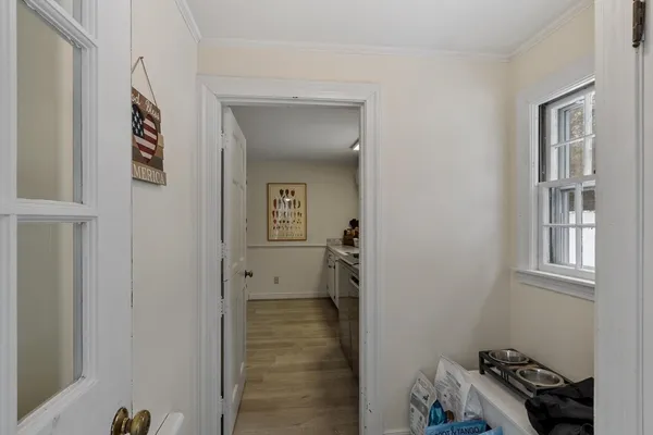 a view of a hallway with closet and a livingroom