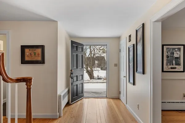 a view of a livingroom with wooden floor and furniture