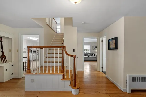 a view of a hallway with entryway door wooden floor and front door