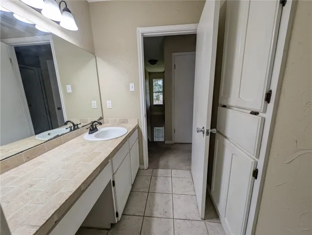 a bathroom with a sink a vanity and a mirror