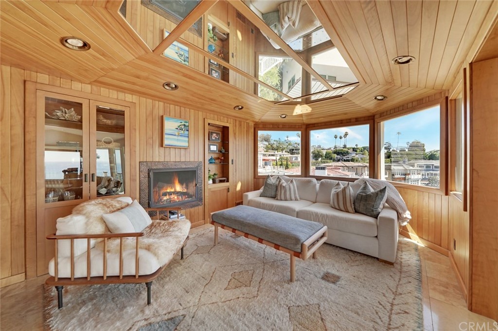 37 Emerald Bay Laguna Beach, CA 92651 - Photo 25 of 52 a living room with furniture a fireplace and a large window
