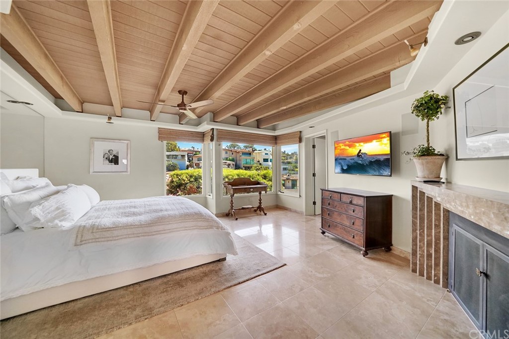 37 Emerald Bay Laguna Beach, CA 92651 - Photo 32 of 52 a spacious bedroom with a bed and a flat screen tv