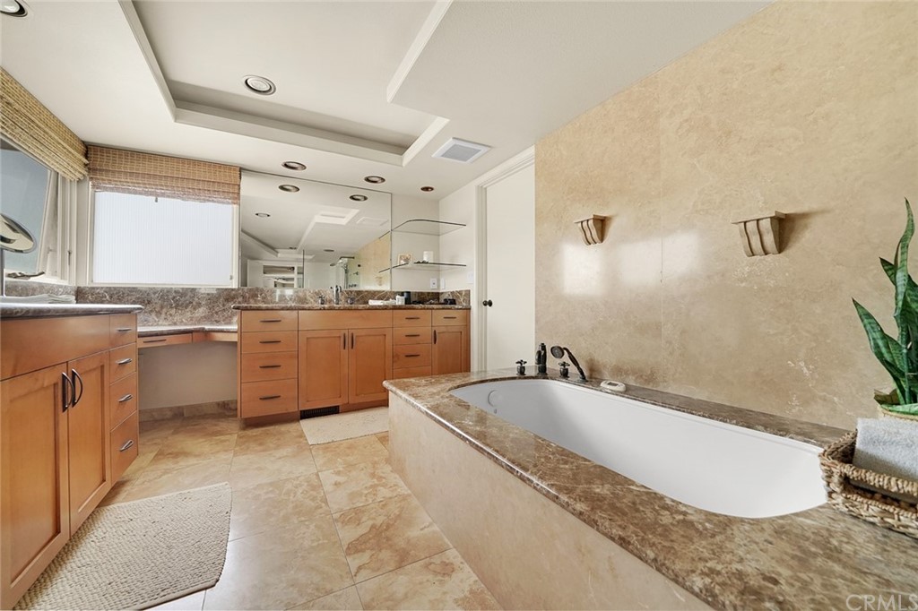 37 Emerald Bay Laguna Beach, CA 92651 - Photo 35 of 52 a large bathroom with a granite countertop tub sink and mirror