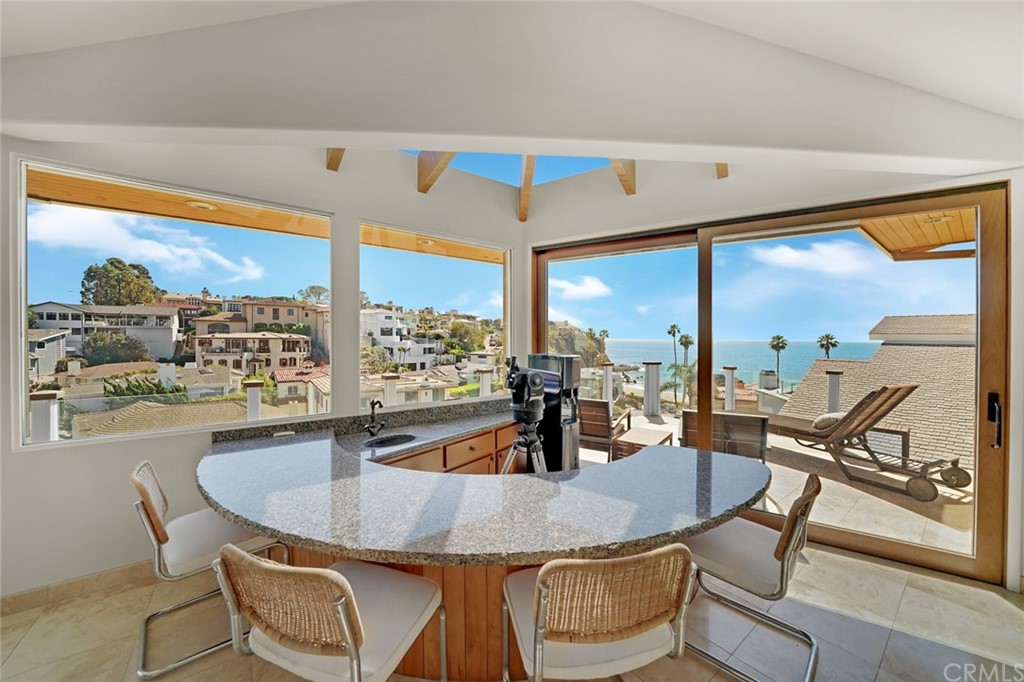 37 Emerald Bay Laguna Beach, CA 92651 - Photo 5 of 52 a kitchen with a table and chairs next to a large window
