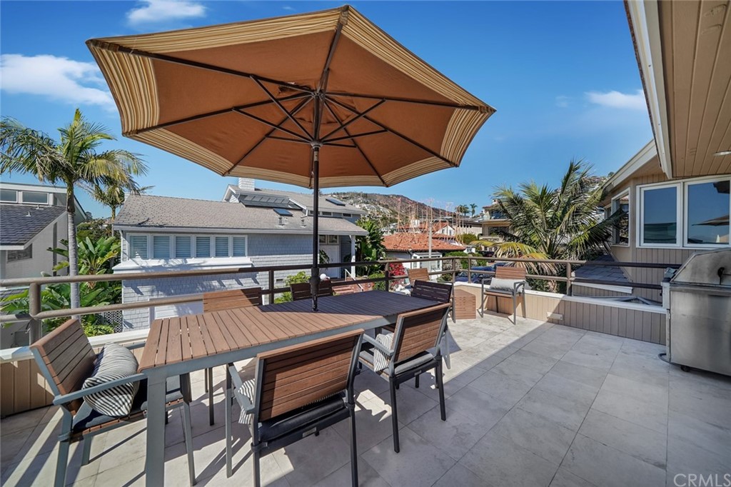 37 Emerald Bay Laguna Beach, CA 92651 - Photo 10 of 52 a view of a patio with a table and chairs under an umbrella