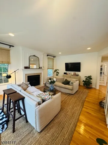 a living room with furniture a fireplace and a table