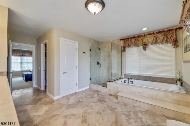 a bathroom with a tub and shower