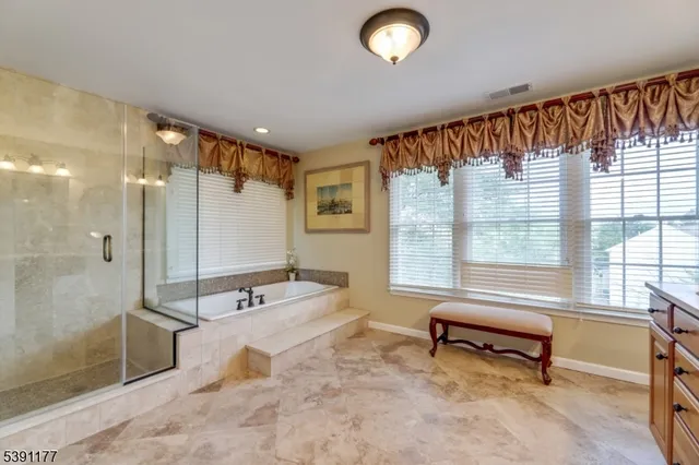 a spacious bathroom with a double vanity sink and a mirror