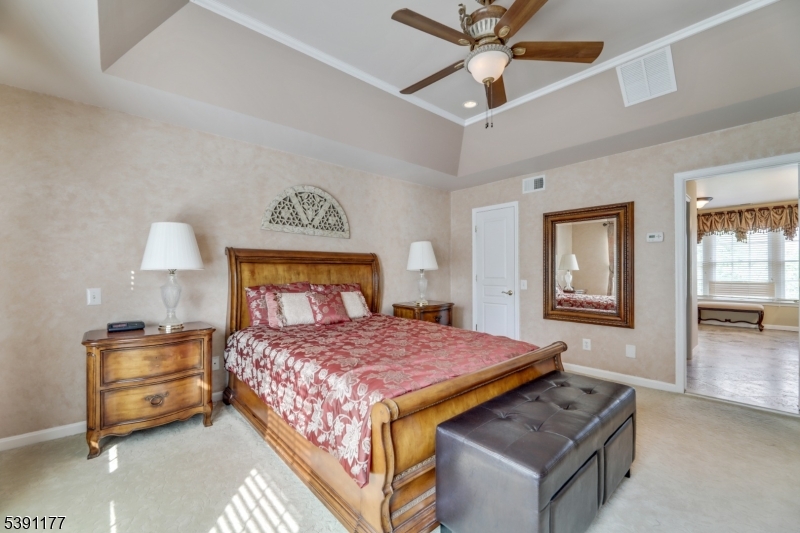 2 Bedford Drive Bernards, NJ 07920 - Photo 30 of 33 a bedroom with a bed and a chandelier