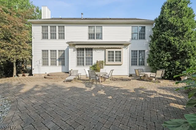 a front view of a house with yard and seating space