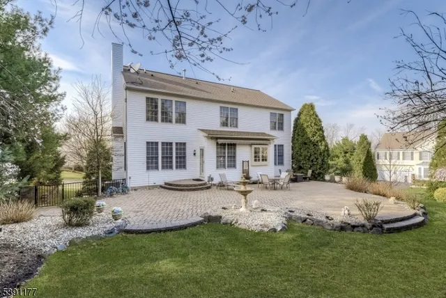 a front view of a house with a garden and yard
