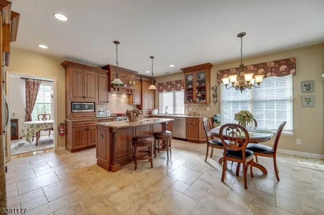 a dining room filled chandelier and fireplace