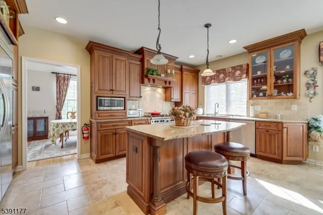 a kitchen with sink cabinets and chairs