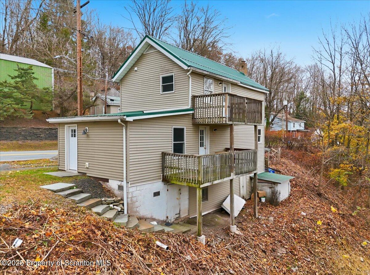 760 Hudson Street Hawley, PA 18428 - Photo 3 of 31 a view of a small house with a yard chairs and wooden fence