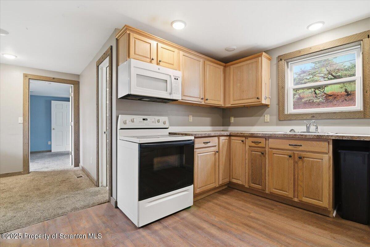 760 Hudson Street Hawley, PA 18428 - Photo 8 of 31 a kitchen with stainless steel appliances granite countertop a stove a sink and a microwave
