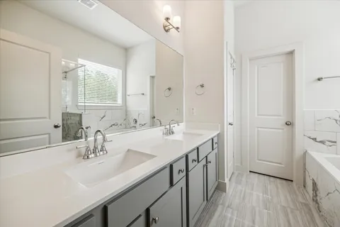 a bathroom with a sink double vanity and a mirror