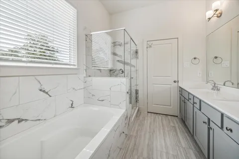 a bathroom with a bathtub and a sink