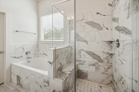 a bathroom with bathtub and shower