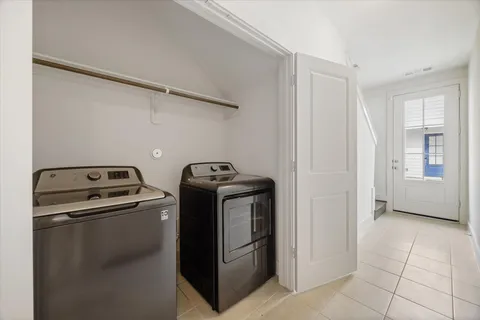 a view of a storage and utility room with washer and dryer
