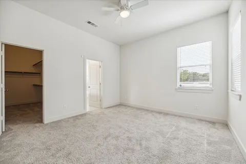 an empty room with windows and closet