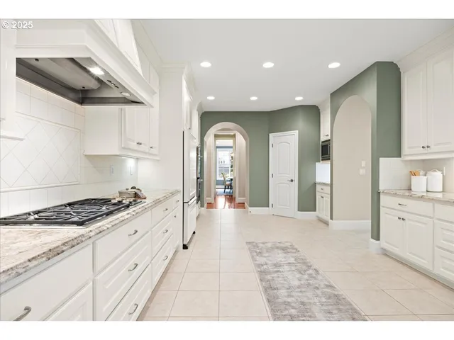 a hallway with sink and mirror