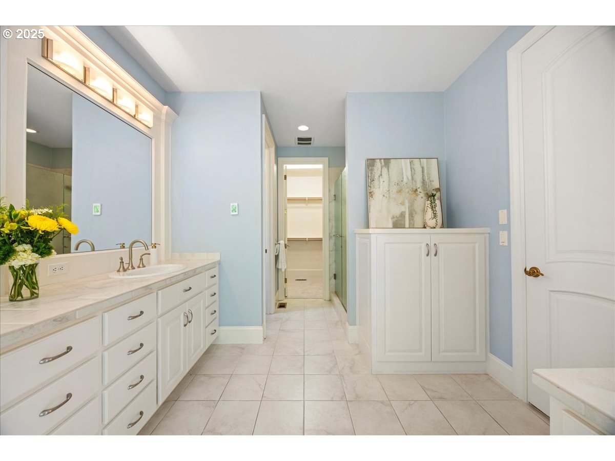 5436 Southwest Champion Place Portland, OR 97225 - Photo 25 of 37 a bathroom with a double vanity sink and mirror