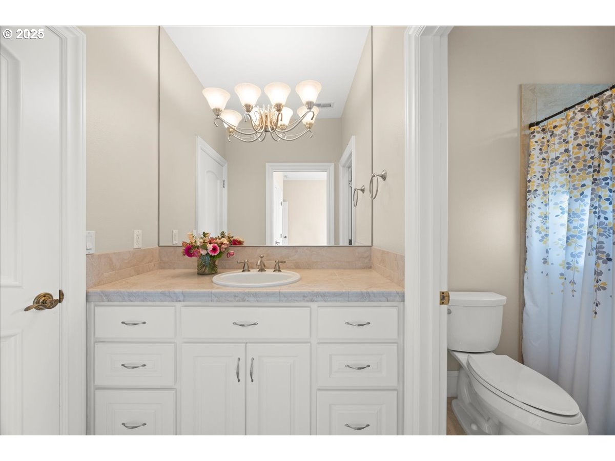 5436 Southwest Champion Place Portland, OR 97225 - Photo 32 of 37 a bathroom with a sink a toilet and a mirror