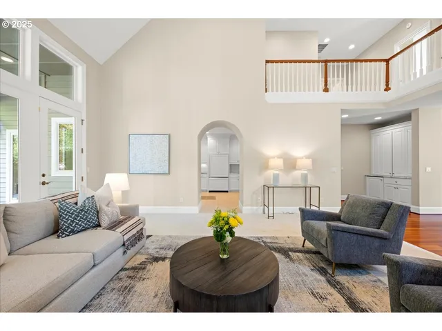 a living room with furniture and a chandelier