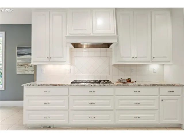 a view of a kitchen with a refrigerator and a window