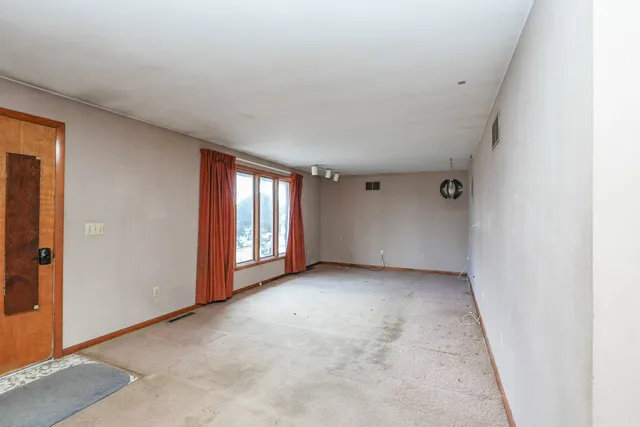 a view of a livingroom with a chandelier fan