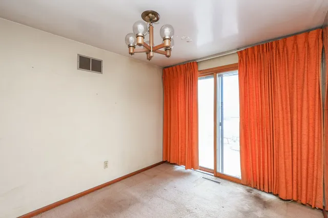 a view of a livingroom with kitchen and furniture
