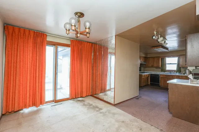 a view of a kitchen with a sink and a refrigerator