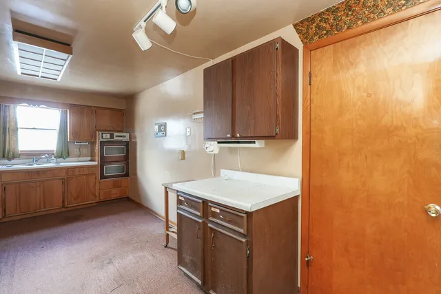 a kitchen with stainless steel appliances granite countertop a stove a sink and a refrigerator