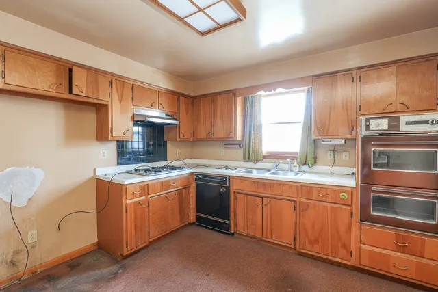 a kitchen with a stove and a cabinets