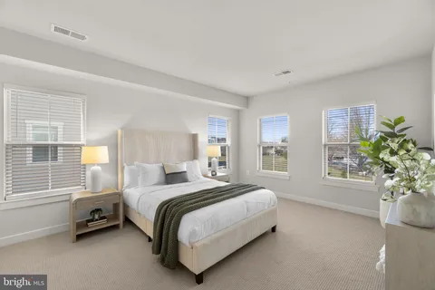 a spacious bedroom with a bed and a window