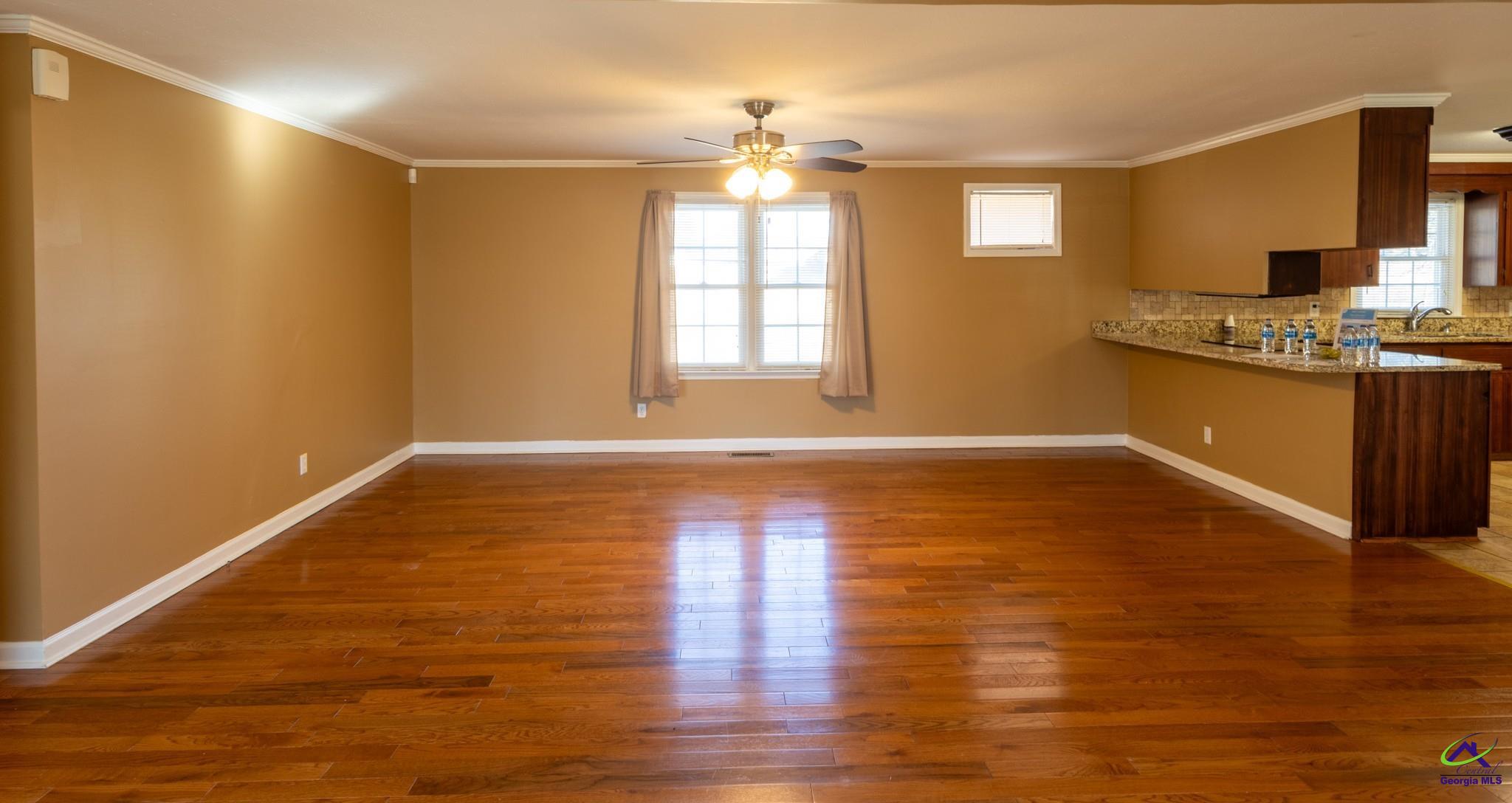 3491 Sandy Circle Macon, GA 31216 - Photo 7 of 47 a view of an empty room with window and wooden floor