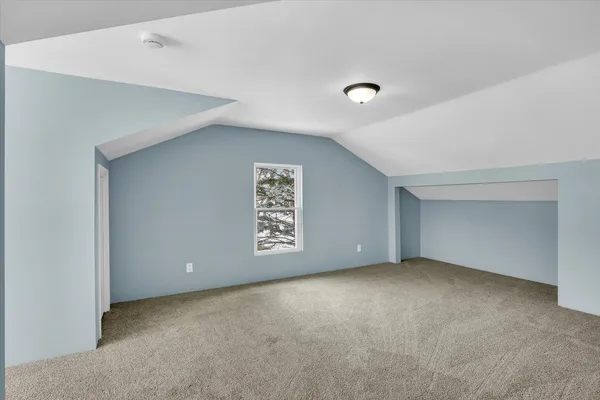 a view of a big room with windows and chandelier