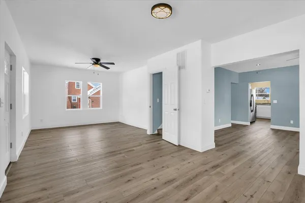 wooden floor in an empty room with a window