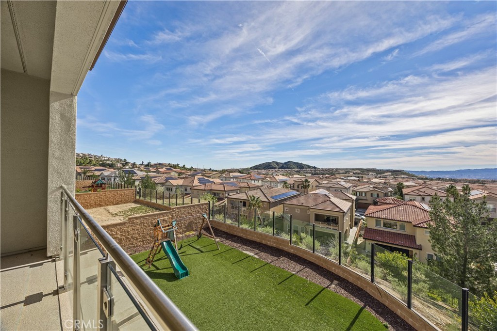 20638 Deer Grass Court Porter Ranch, CA 91326 - Photo 34 of 50 a view of a city from a balcony with seating space