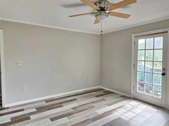 a view of empty room with ceiling fan