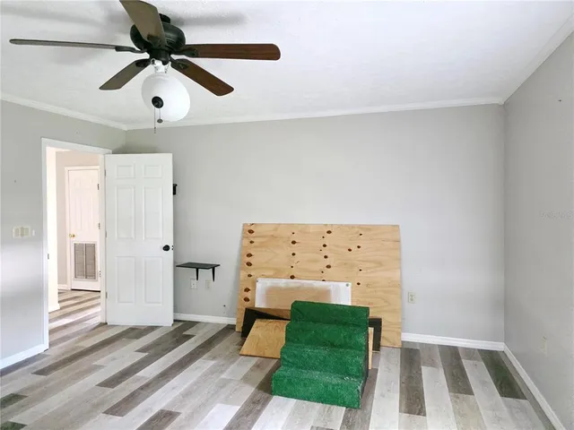 a bedroom with a bed and a ceiling fan