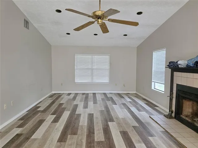 wooden floor in an empty room with a fireplace