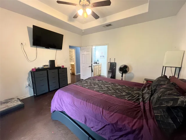 a bedroom with a bed and a flat screen tv