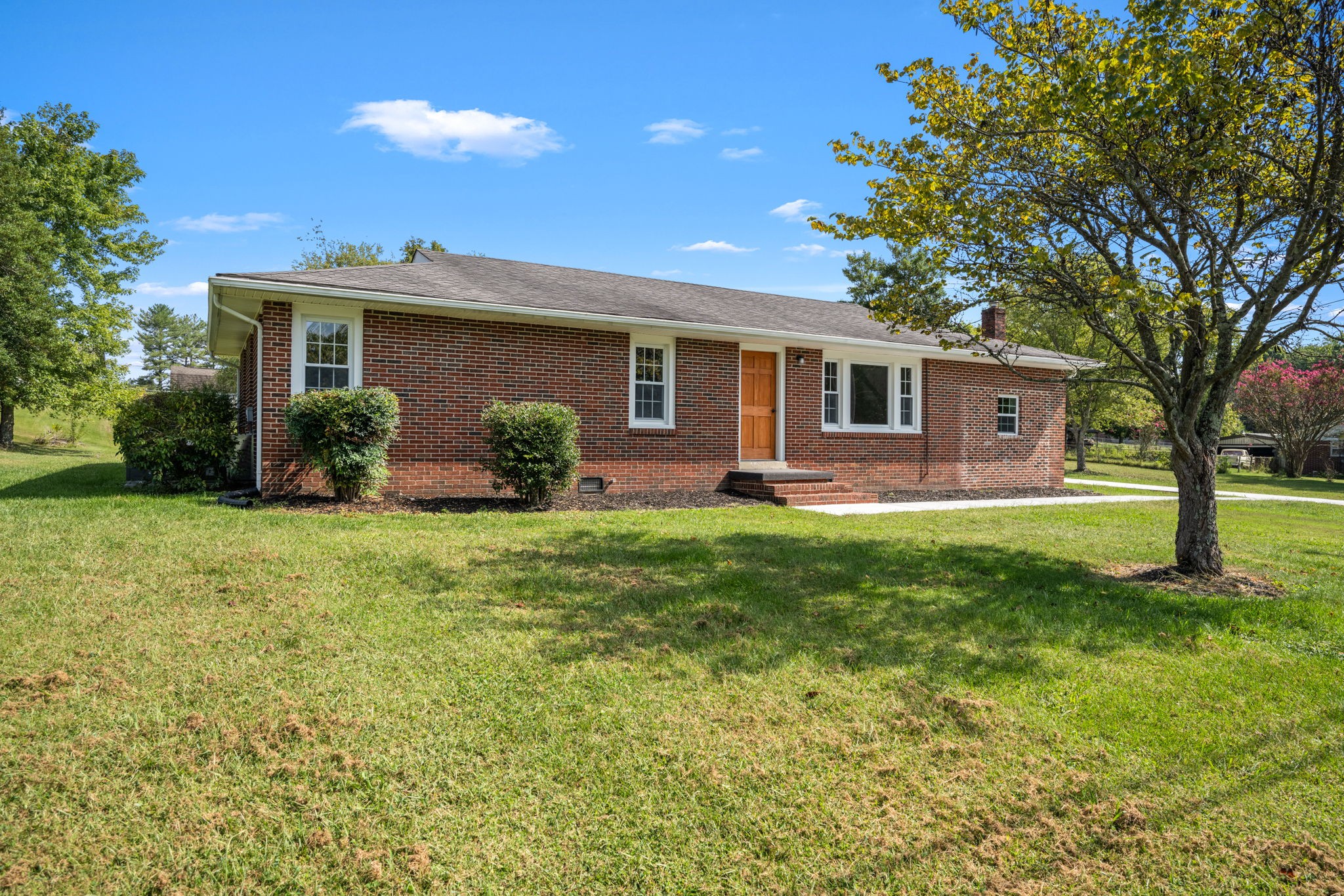 a front view of house with yard and green space